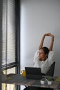 A calm businesswoman is relaxing and rest from computer feel stress free relief in office.