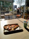 Two piece of pizza pn the plate with street view