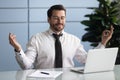 Calm caucasian employee meditate at workplace in office Royalty Free Stock Photo