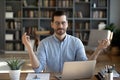 Calm Caucasian male worker meditate at workplace Royalty Free Stock Photo