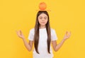 calm child with grapefruit and book on yellow background, health