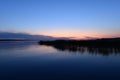 Calm cloudless blue sky over the lake in the twilight glow in the night silence Royalty Free Stock Photo