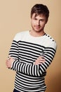 Calm and collected style. Studio portrait of a stylishly-dressed young man standing with his arms crossed. Royalty Free Stock Photo