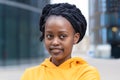 Calm confident fashionable young black lady, beautiful trendy african american woman with dreadlocks in yellow clothes Royalty Free Stock Photo