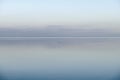 Calm, cool and relaxing front view of the ocean horizon, copy space on top. Mist over the sea on a new morning. Clear