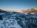 Calm and cosy fairy-tale village Kryvorivnia covered with snow in the Carpathians mountains, aerial view. Typical landscape in