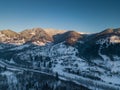 Calm and cosy fairy-tale village Kryvorivnia covered with snow in the Carpathians mountains, aerial view. Typical landscape in