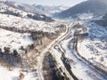 Calm and cosy fairy-tale village Kryvorivnia covered with snow in the Carpathians mountains, aerial view. Typical landscape in