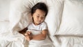 Cute little Asian girl relax sleeping in bed Royalty Free Stock Photo