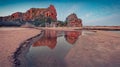 Calm dawn on the Black sea coast. Red cliffs on Bolata beach. Amazing spring seascape of Black sea.