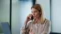 Calm director talking smartphone at office close up. Serious lady making call Royalty Free Stock Photo