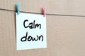 Calm down. Note is written on a white sticker that hangs with a Royalty Free Stock Photo