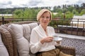 Calm elegant blonde woman drinking coffee outdoors Royalty Free Stock Photo