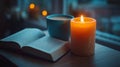 A calm evening scene with an open book, a cup of coffee, and a candle flickering softly on a small bedside table Royalty Free Stock Photo