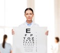 Calm female doctor with eye chart