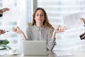 Calm female executive meditating taking break avoiding stressful job