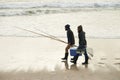 Calm, fishing and men walking on beach together with cooler, tackle box and holiday conversation. Ocean, fisherman and Royalty Free Stock Photo