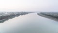 Calm flat river in foggy weather