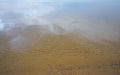 Calm flat water surface with minor ripples in sand below, few white salt crystals visible - Dead Sea at Ein Bokek beach Royalty Free Stock Photo