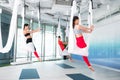 Women and men feeling calm and free practicing flying yoga