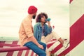 Calm girl drinking blue lemonade and bearded man looking at her Royalty Free Stock Photo