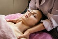 Calm girl having spa facial massage in luxurious beauty salon