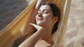 Calm girl lying hammock in sunlight closeup. Carefree beautiful woman relaxing