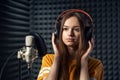 Calm girl in recording studio in headphones with mic Royalty Free Stock Photo