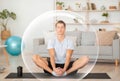 Calm handsome millennial european guy meditates with closed eyes in living room interior