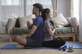 Calm healthy young couple doing yoga, meditating with eyes closed namaste hands at home together Royalty Free Stock Photo