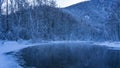 A calm, ice-free river in a winter forest. Altai Royalty Free Stock Photo