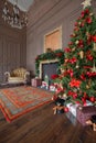 Calm image of interior Classic New Year Tree decorated in a room with fireplace