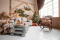 Calm image of interior modern home living room decorated christmas tree and gifts, sofa, table covered with blanket. Royalty Free Stock Photo