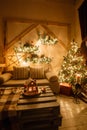 Calm image of interior modern home living room decorated christmas tree and gifts, sofa, table covered with blanket. Royalty Free Stock Photo