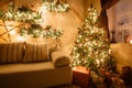 Calm image of interior modern home living room decorated christmas tree and gifts, sofa, table covered with blanket. Royalty Free Stock Photo