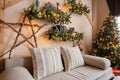 Calm image of interior modern home living room decorated christmas tree and gifts, sofa, table covered with blanket. Royalty Free Stock Photo