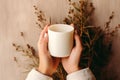Womans hands holding a plan white blank mug cup, beige neutral rustric cottagecore Royalty Free Stock Photo
