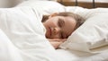 Calm kid girl sleeping in bed covered with warm duvet Royalty Free Stock Photo