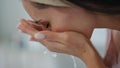 Calm lady cleaning face home close up. Satisfied woman splashing water on skin Royalty Free Stock Photo