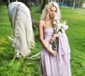 Calm lady with horse and bouquet of flowers