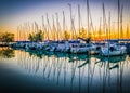 Calm lake, harbor and pier at sunset. Royalty Free Stock Photo