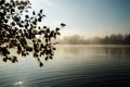Calm autumn lake in a morning mist