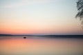 Calm lake sunset boat couple minimalism Royalty Free Stock Photo