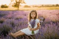 Calm Little Girl on Lavender Field with Bouquet