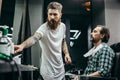 Calm man closing his eyes while professional barber working Royalty Free Stock Photo