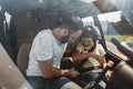 Calm man instructing satisfied boy in helicopter Royalty Free Stock Photo