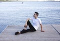 Calm man resting on wooden pier Royalty Free Stock Photo