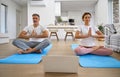 Calm middle aged couple learning online yoga meditating using laptop at home. Royalty Free Stock Photo