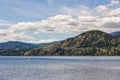 Calm morning lake in British Columbia Canada blue sky with white clouds Royalty Free Stock Photo