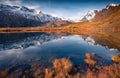 Calm morning scene of Stellisee lake with Stockhorn peak on background.